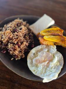 a plate of food with fried rice and fried eggs at Parque Indigo Nature Lodge, Rincón de la Vieja in Liberia