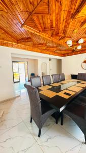 a dining room with a large table and chairs at The Golden Palace in Bulawayo