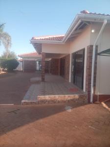 a house with a patio in front of it at The Golden Palace in Bulawayo +6 photos