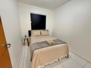a bedroom with a bed with a stuffed animal on it at Apto Com 2 Ar condicionados, Lava e seca, Wi-Fi in Caruaru +16 photos