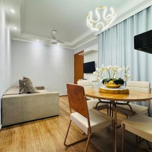 a living room with a table and a couch at Casa Valentina 2 in Catanduva