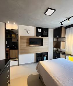 a bedroom with a bed and a kitchen at Studio Estilo Industrial - 01 - BARRETO - in Mossoró