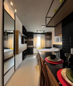 a kitchen with a table and a dining room at Studio Estilo Industrial - 01 - BARRETO - in Mossoró +31 photos