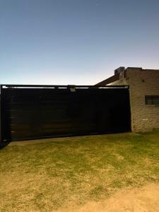 a large black garage door on the side of a building at Richard House in Villa Dolores