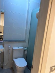 a blue bathroom with a toilet and a sink at D-Bay Cabin in Zāwiyat ‘Abd al Mun‘im +8 photos