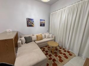 a living room with a couch and a table at D-Bay Cabin in Zāwiyat ‘Abd al Mun‘im