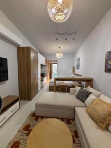 a living room with a couch and a dining room at D-Bay Cabin in Zāwiyat ‘Abd al Mun‘im