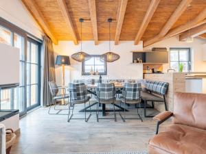a kitchen and dining room with a table and chairs at Tauernlodge Chalet Salzach in Niedernsill