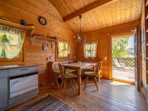 a kitchen with a table and chairs in a cabin at Pauls-Hütte in Hippach