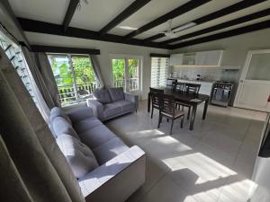 a large living room with a couch and a table at Savusavu Terraces - Unit 1 in Savusavu