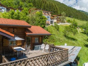 a house with a deck with a table and chairs at Pauls-Hütte in Hippach +9 photos
