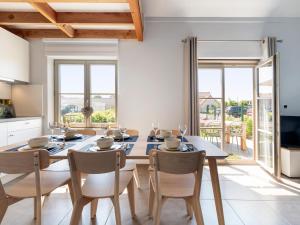 a kitchen and dining room with a table and chairs at Westhinder II H14 in Koksijde