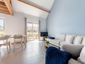 a living room with a couch and a table at Westhinder II H14 in Koksijde