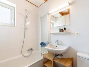 a white bathroom with a sink and a shower at Westhinder II H14 in Koksijde +26 photos