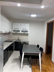 a kitchen with a table and chairs in it at Dardi in Peje +2 photos