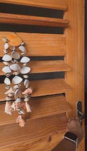 a person is looking at a bunch of shells on a door at Por do sol residence in Aracati
