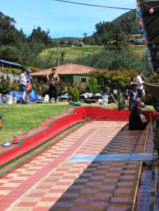 a group of people standing around a red and green ramp at Camping el triunfo in Montecillo +18 photos
