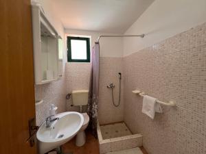 a bathroom with a sink and a shower at Family friendly seaside apartments Cove Rapak, Hvar - 12779 in Gdinj