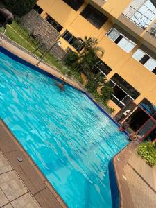 an overhead view of a large swimming pool in a building at KIGALI E6 APARTMENTs RESORTS in Kigali +35 photos