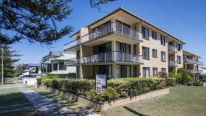 an apartment building with balconies and bushes at Flinders Lodge Unit 5 - Lifestyle Yamba in Yamba