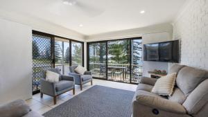 a living room with a couch and chairs and a tv at Flinders Lodge Unit 5 - Lifestyle Yamba in Yamba