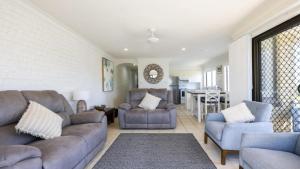 a living room with a couch and two chairs at Flinders Lodge Unit 5 - Lifestyle Yamba in Yamba
