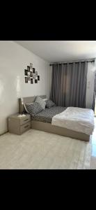a bedroom with a bed and a dresser and a window at Relax appartement in Nouakchott