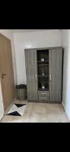 a room with a wooden cabinet with two plants in it at Relax appartement in Nouakchott +1 photo