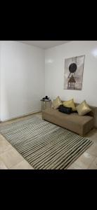 a living room with a couch and a rug at Relax appartement in Nouakchott