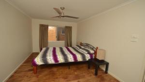 a bedroom with a bed and a ceiling fan at Pilot Unit 2 - Lifestyle Yamba in Yamba