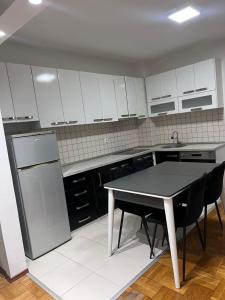 a kitchen with a table and a refrigerator at Dardi in Peje