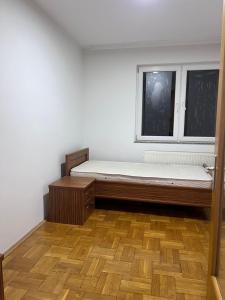 an empty room with a bed and a window at Dardi in Peje