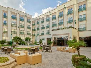 an exterior view of a hotel with tables and chairs at Fiesta Americana Aguascalientes in Aguascalientes