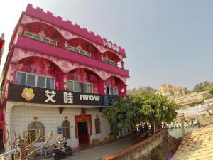 a red and white building with a sign on it at I WoW in Xiaoliuqiu