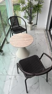 a table and two chairs and a table and chairs at Le Terracotta Panoramic View Bingerville in Bingerville +4 photos