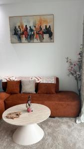 a living room with a table and a couch at Le Terracotta Panoramic View Bingerville in Bingerville