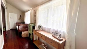 a bathroom with a window and a sink in a room at Surf Side - Lifestyle Yamba in Yamba