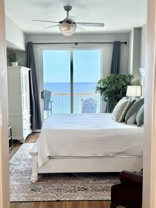 a bedroom with a bed with a view of the ocean at Blue Heron Beach Front in Panama City Beach