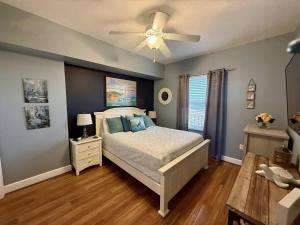 a bedroom with a bed and a ceiling fan at Blue Heron Beach Front in Panama City Beach +70 photos