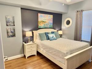 a bedroom with a large bed and a window at Blue Heron Beach Front in Panama City Beach