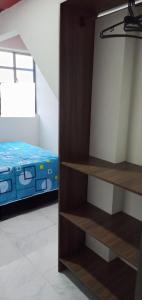 a bedroom with a bed and shelves in a room at Apartaestudio in Tocancipá +1 photo