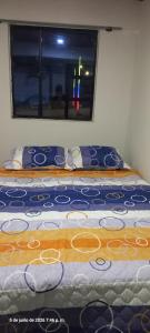 a bed in a room with a window at Apartaestudio in Tocancipá