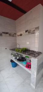 a kitchen with a stove and some pots and pans at Apartaestudio in Tocancipá