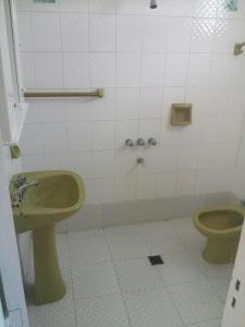 a bathroom with a toilet and a green bidet at Rocio de Luna in Mina Clavero