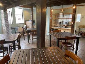 a restaurant with wooden tables and chairs and a kitchen at base sanablend - Vacation STAY 04909v in Kyotango