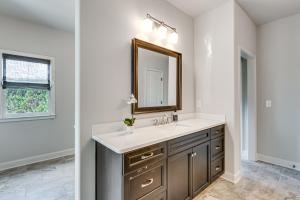 a bathroom with a sink and a mirror at Executive 5BR Stay in Duluth w/ Pool Access in Duluth +32 photos