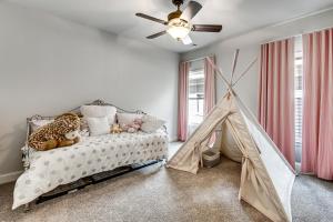 a bedroom with a bed and a play tent at Executive 5BR Stay in Duluth w/ Pool Access in Duluth