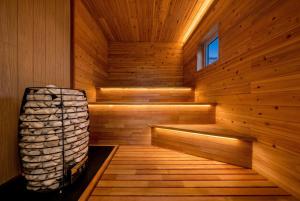 a wooden sauna with a bench in the middle at The Horizon Residence in Makubetsu