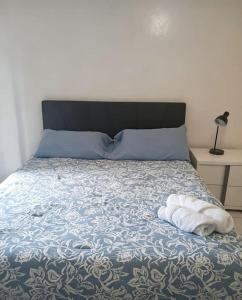 a bed with two towels sitting on top of it at Comfortable Stay O in Hollywood