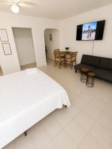 a bedroom with a bed and a couch and a table at Comfortable Stay O in Hollywood